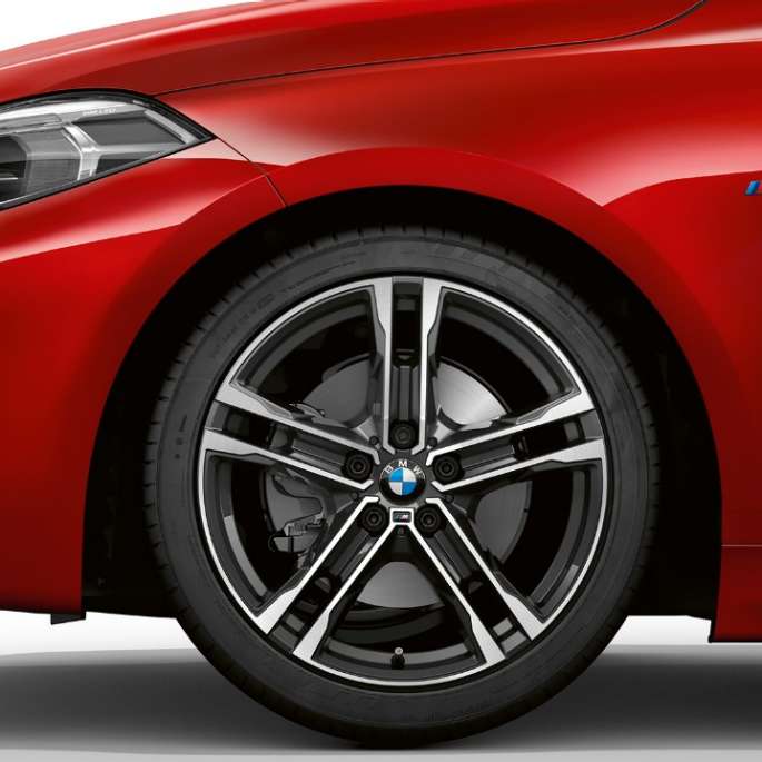 BMW 1 Series Model M Sport, front from the side. BMW 1 Series Model M Sport in Melbourne Red metallic, front from the side with 17" M light-alloy wheel Double-spoke 550 M style in Bicolour.