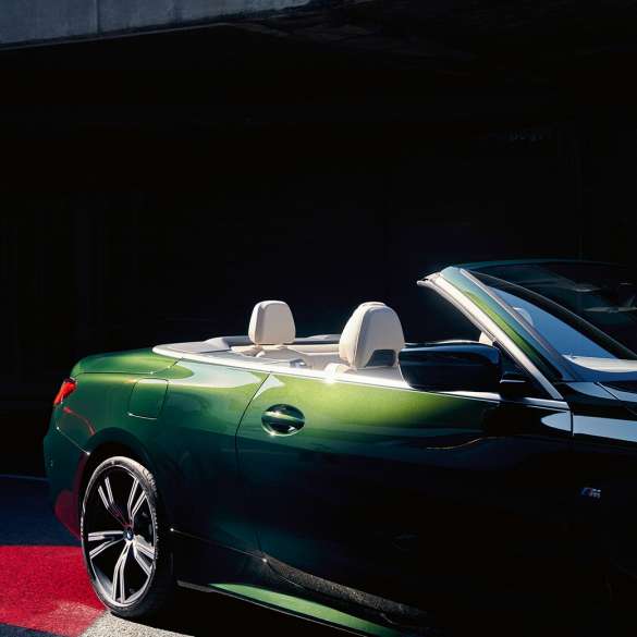 Three-quarter front view BMW 4 Series Convertible G23 2020 driving BMW 4 Series Convertible G23 2020 Sanremo Green metallic three-quarter rear view in motion