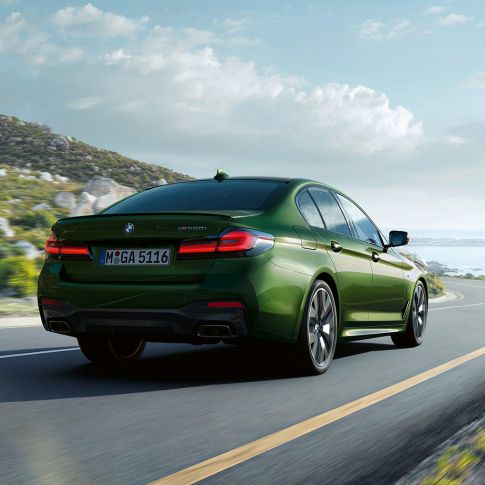 BMW M550i xDrive Sedan G30 LCI Facelift 2020 rear view BMW M550i xDrive Sedan G30 LCI Facelift 2020 BMW Individual Verde Ermes metallic rear view driving on highway