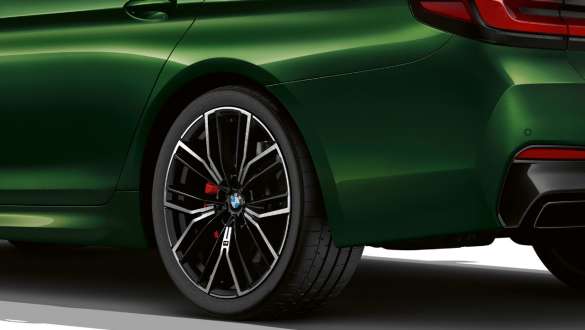 BMW M550i xDrive Sedan with M sport differential G30 LCI Facelift 2020 close-up rear wheel BMW M550i xDrive Sedan with M sport differential G30 LCI Facelift 2020 BMW Individual Verde Ermes metallic close-up rear wheel