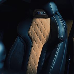 BMW M8 Competition Coupé, M Sport seat. BMW M8 Competition Coupé, M Sport seat with M8 badge and upholstery in full leather 'Merino' Black with contrast Midrand Beige.