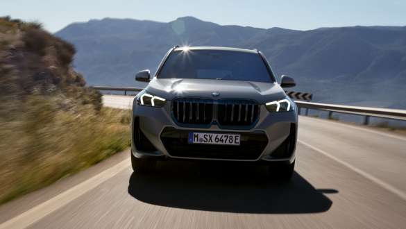 BMW X1 U11 PHEV front view BMW X1 U11 BEV front view driving on ountry road