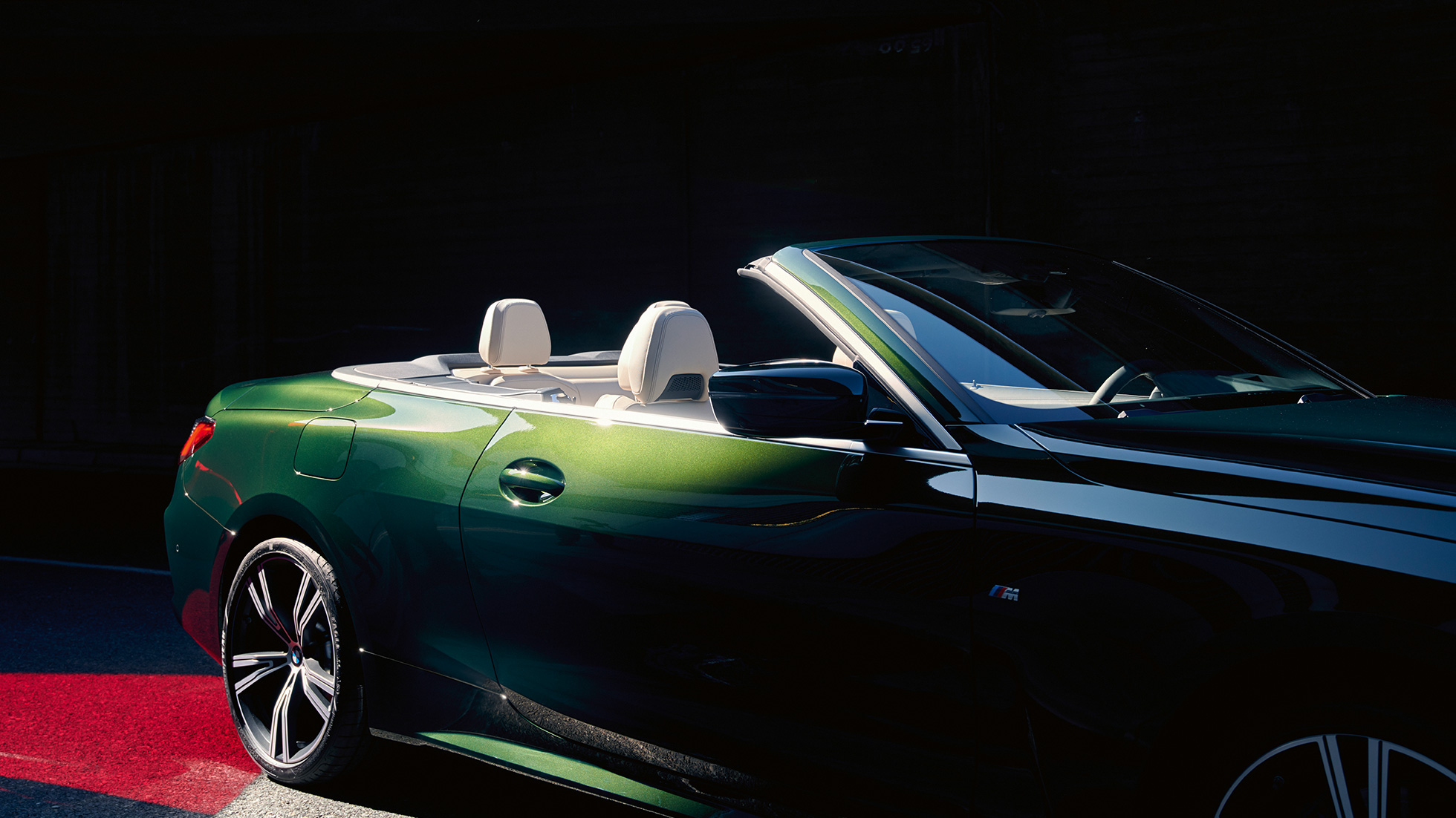Three-quarter front view BMW 4 Series Convertible G23 2020 driving BMW 4 Series Convertible G23 2020 Sanremo Green metallic three-quarter rear view in motion