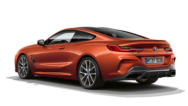 A still shot of the BMW 8 Series Coupé in Sunset Orange metallic against a white background.