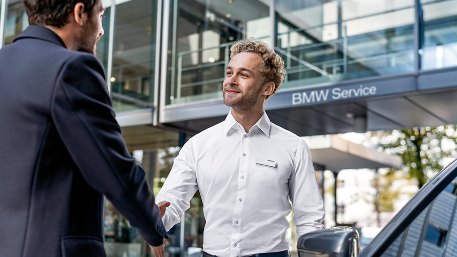 BMW employee greets a customer BMW employee greets a customer