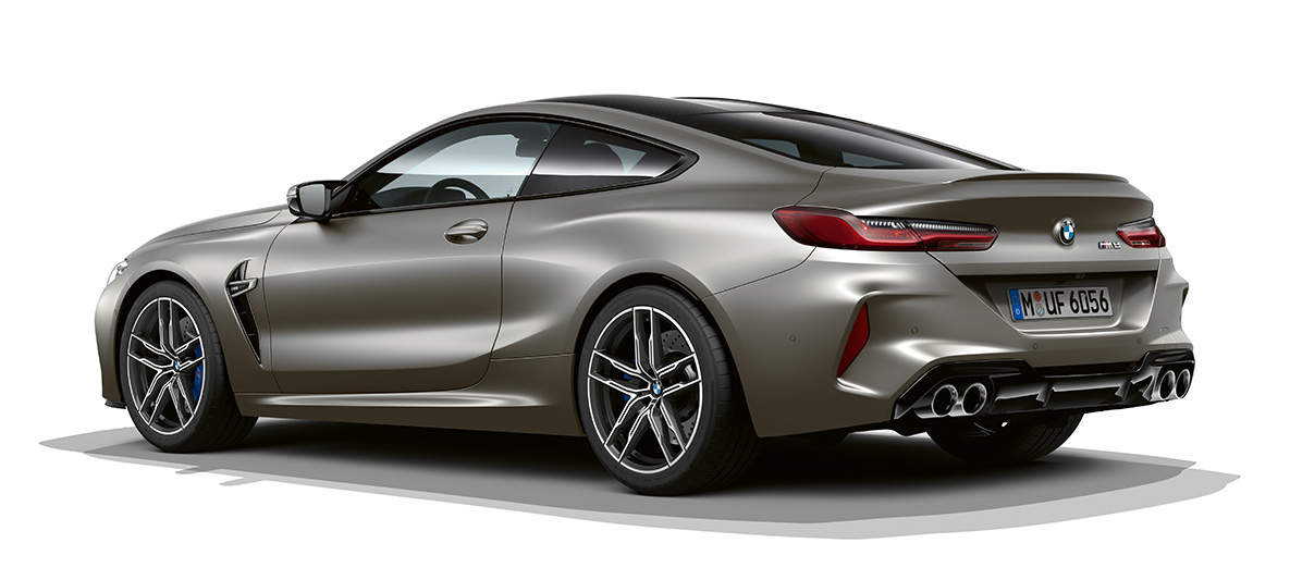 BMW M8 Coupé, three-quarter side view rear. BMW M8 Coupé in Frozen Dark Silver, three-quarter side view from rear.