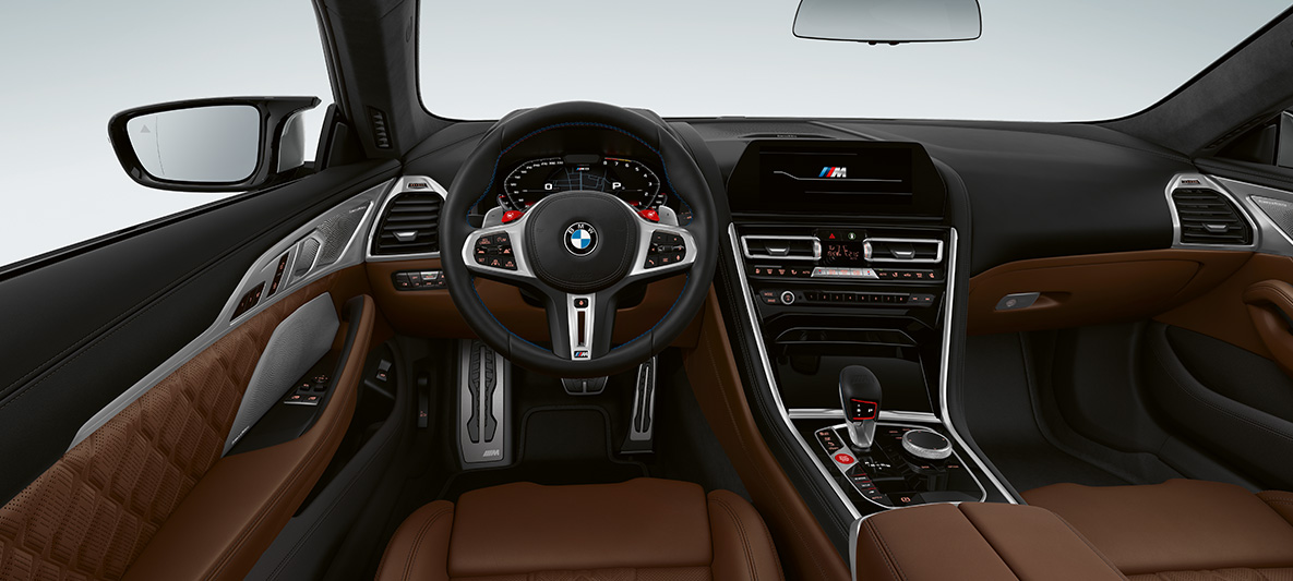 BMW M8 Coupé, cockpit. BMW M8 Coupé, cockpit with M leather steering wheel with M1/M2 buttons in red.