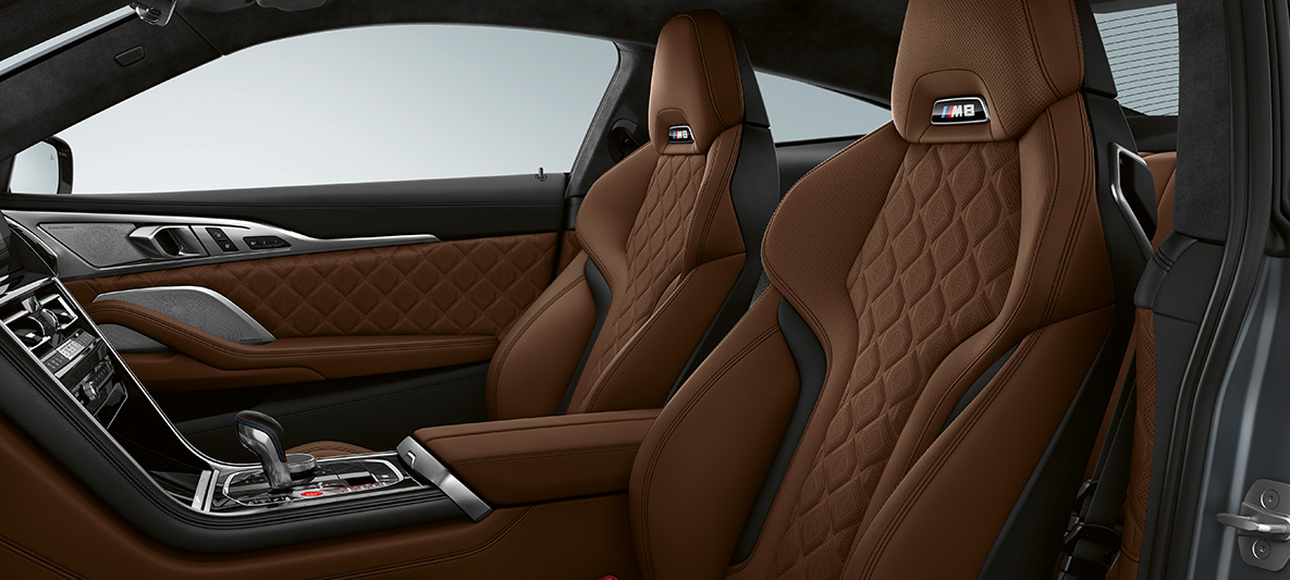 M Sport seats with M badge. BMW M8 Coupé, interior with M Sport seats in full fine-grain leather 'Merino' Taruma Brown.