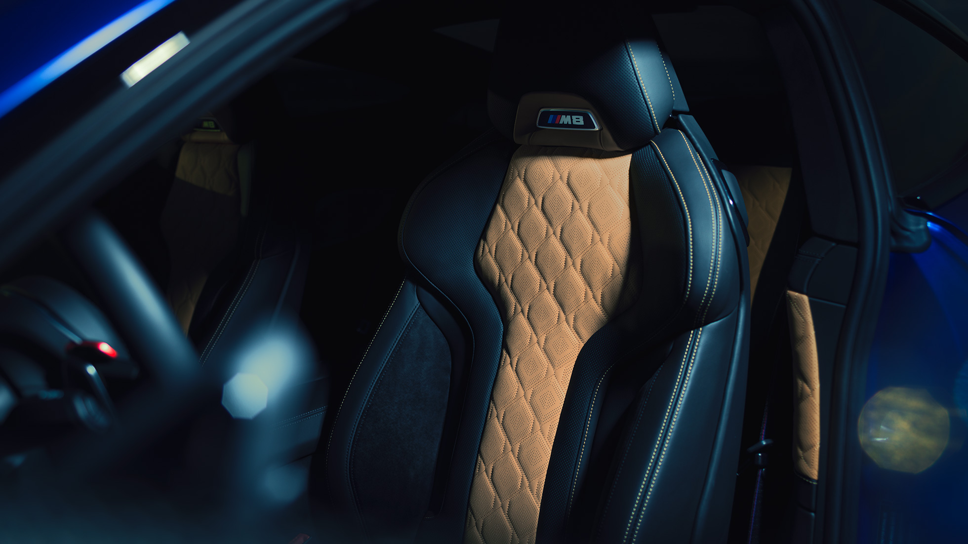 BMW M8 Competition Coupé, M Sport seat. BMW M8 Competition Coupé, M Sport seat with M8 badge and upholstery in full leather 'Merino' Black with contrast Midrand Beige.