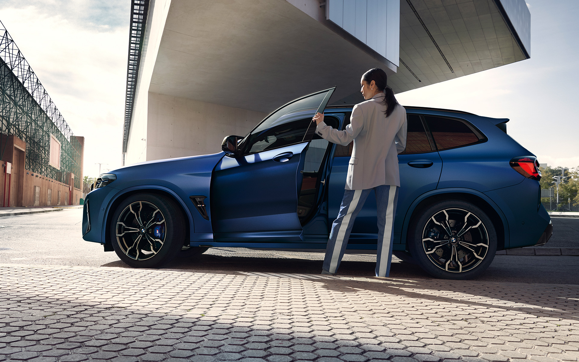 BMW X3 M Competition F97 LCI Facelift 2021 Frozen Marina Bay Blue metallic side view with open door and female model