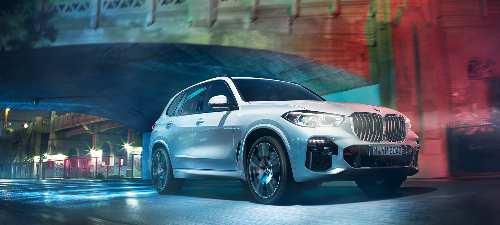 The BMW X5 travelling through the city at night