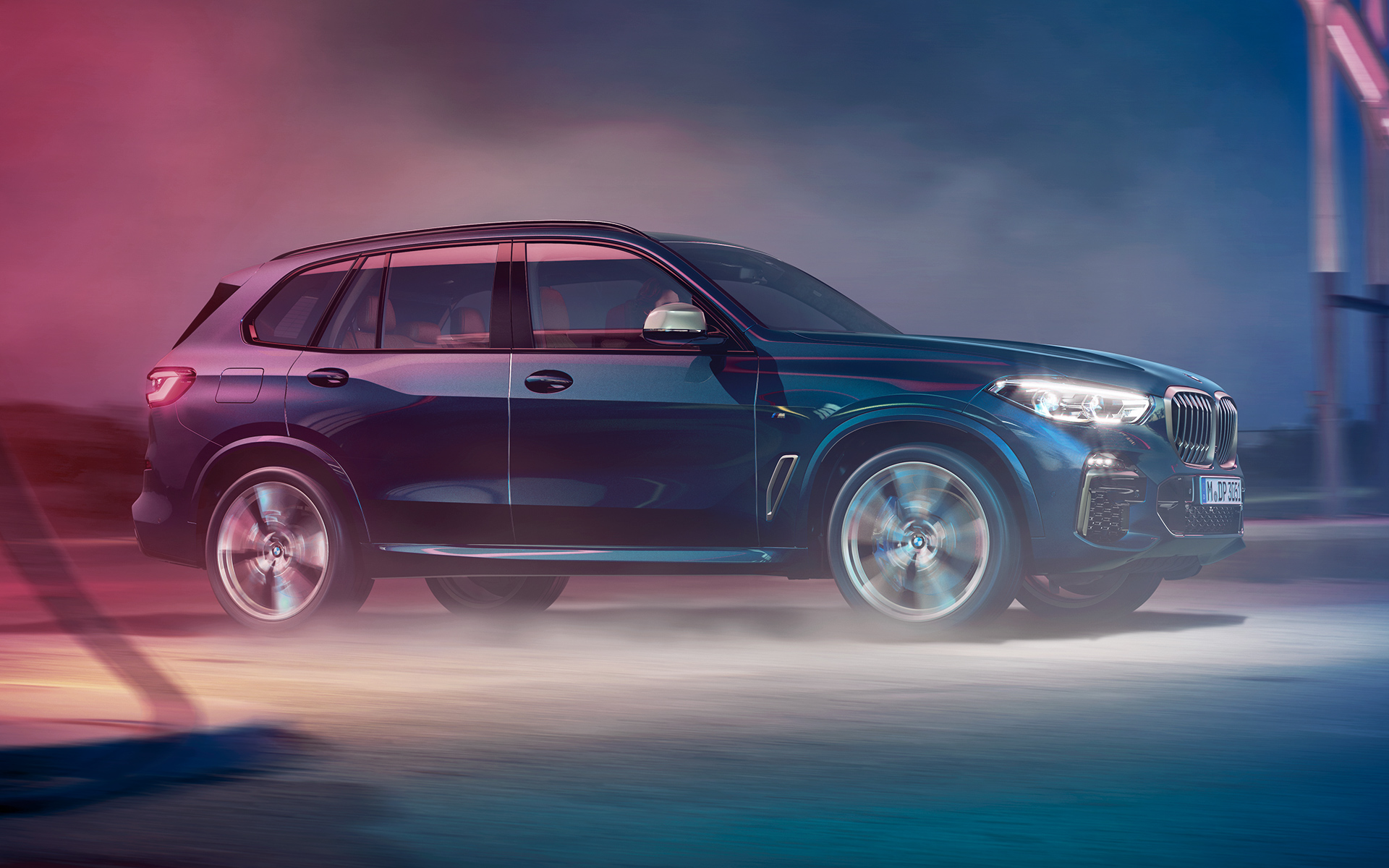 BMW X5 M50d in action Driving shot of the BMW X5 M50d at night in an urban setting