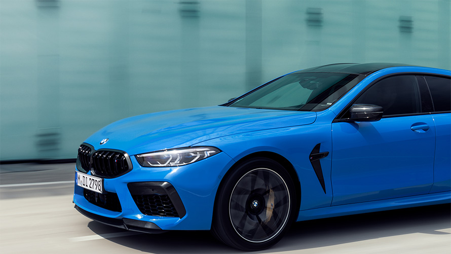 BMW M8 Competition Coupé F92 2019 BMW Individual Voodoo Blue three-quarter side view in section driving 