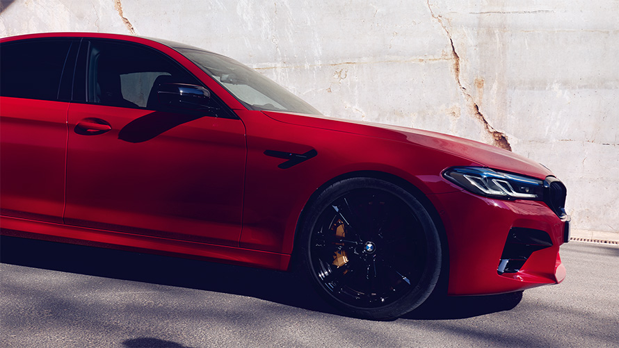 BMW M5 Competition F90 2018 BMW Individual Imola Red side view standing in section